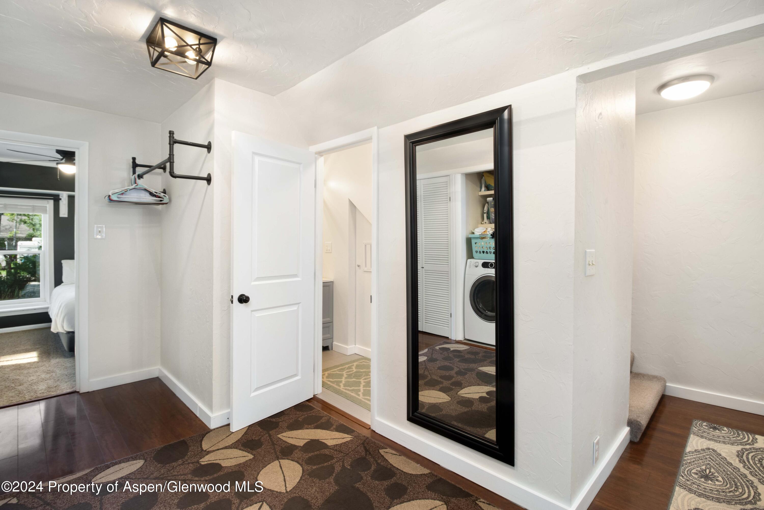 816 East 2nd Street New Castle, CO 81647 - Photo 17 of 32 a view of a hallway with a wooden floor and a bedroom