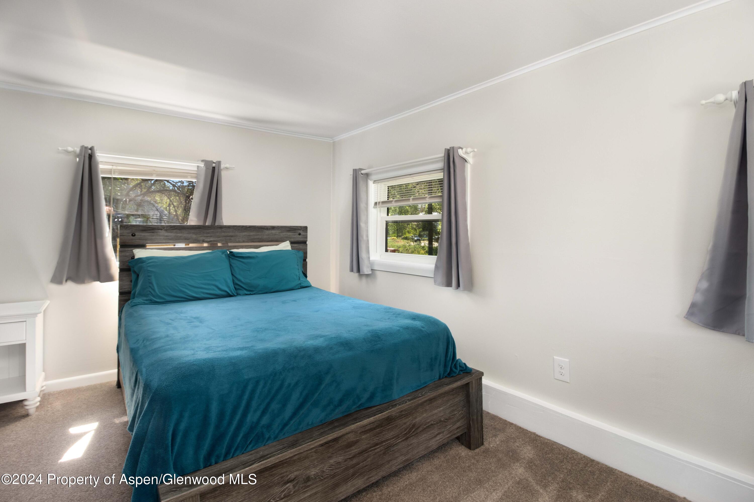 816 East 2nd Street New Castle, CO 81647 - Photo 24 of 32 a bedroom with a bed and a window