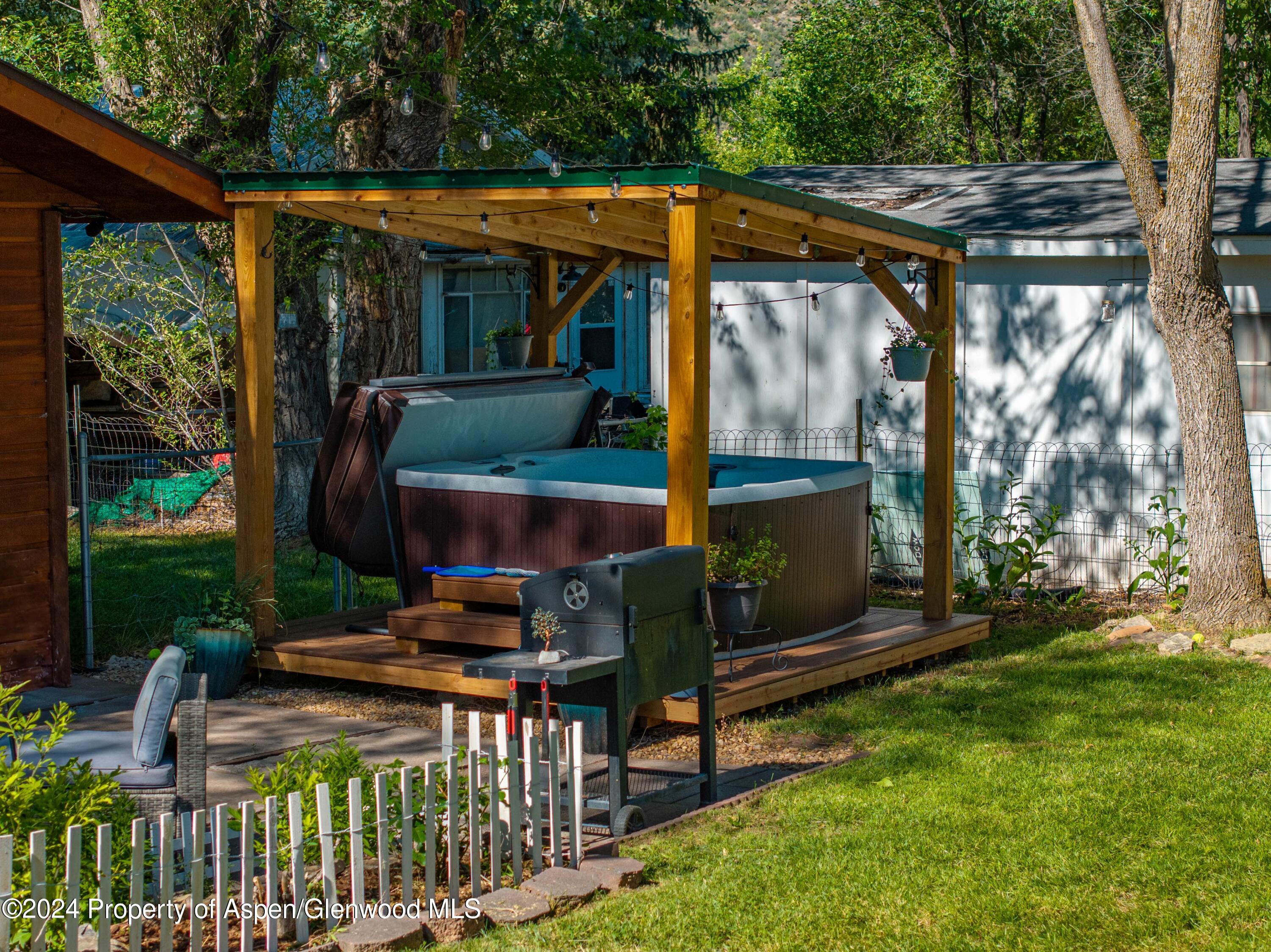 816 East 2nd Street New Castle, CO 81647 - Photo 6 of 32 a view of a patio with table and chairs potted plants with wooden floor and fence