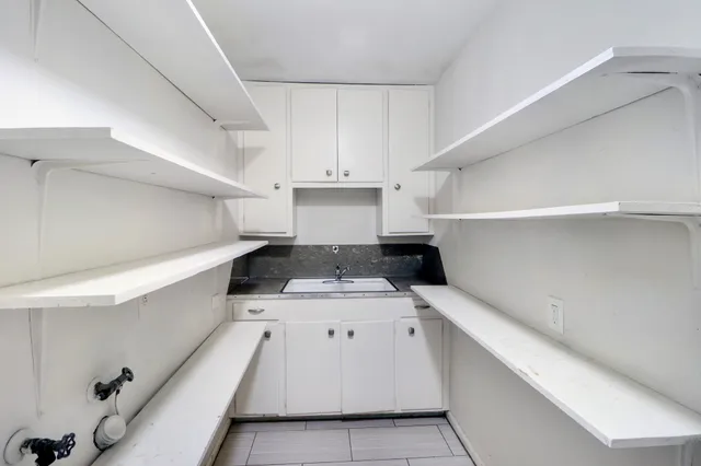a kitchen with a cabinets and white appliances