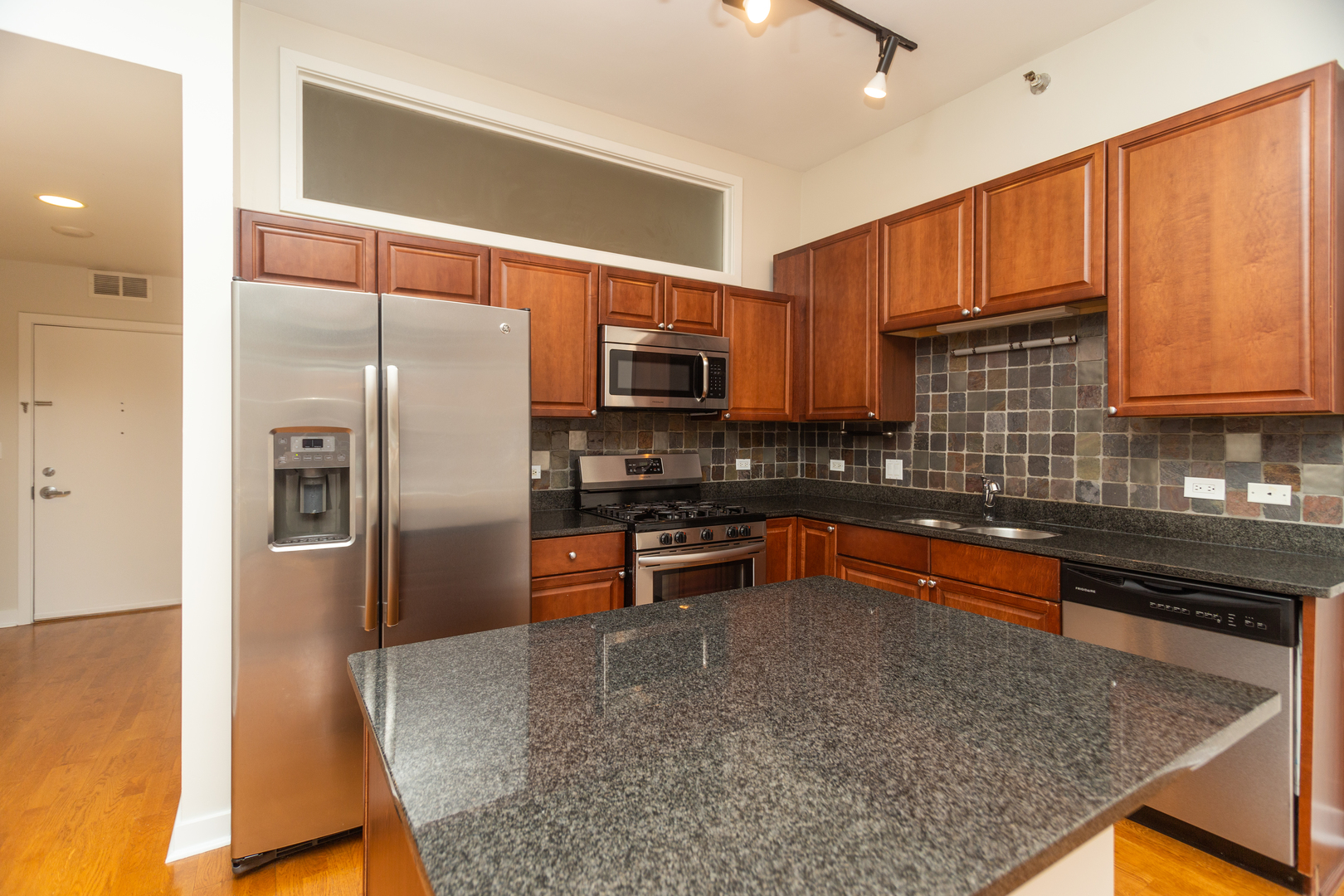 901 West Madison Street, Unit 509 Chicago, IL 60607 - Photo 2 of 14 a kitchen with stainless steel appliances granite countertop a refrigerator a stove top oven a sink and dishwasher