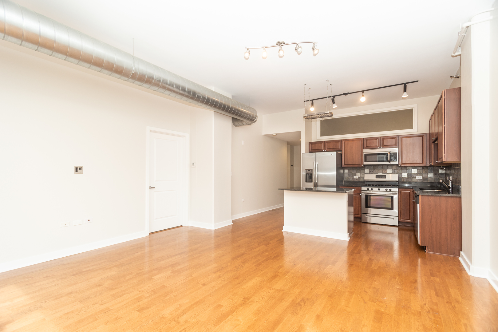 901 West Madison Street, Unit 509 Chicago, IL 60607 - Photo 3 of 14 a large kitchen with cabinets