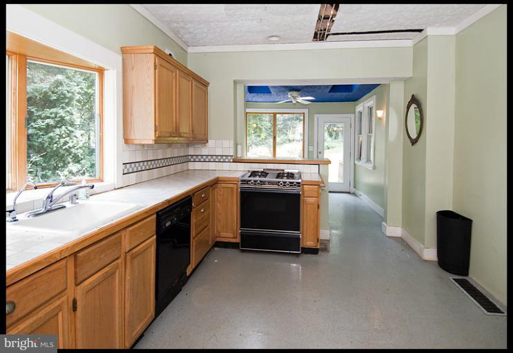 2311 Garrett Road White Hall, MD 21161 - Photo 9 of 13 a kitchen with stainless steel appliances granite countertop a stove a sink and a microwave