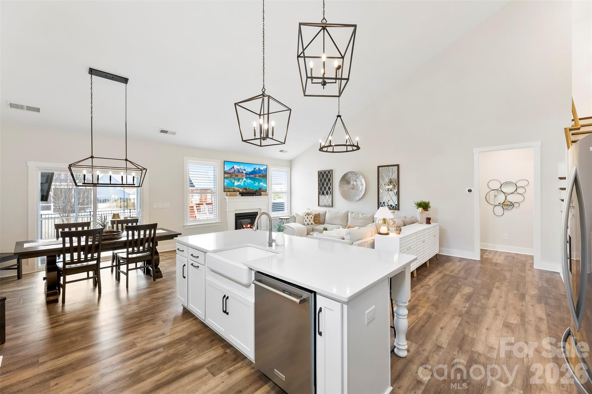 6283 Six String Court Fort Mill, SC 29708 - Photo 11 of 40 a large white kitchen with a sink and dishwasher a stove with wooden floor