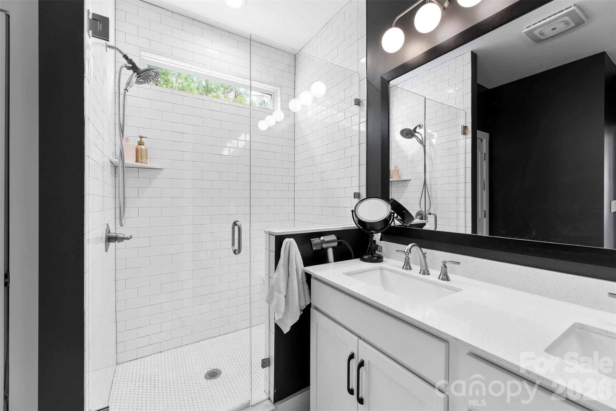 6283 Six String Court Fort Mill, SC 29708 - Photo 22 of 40 a bathroom with a double vanity sink mirror and shower