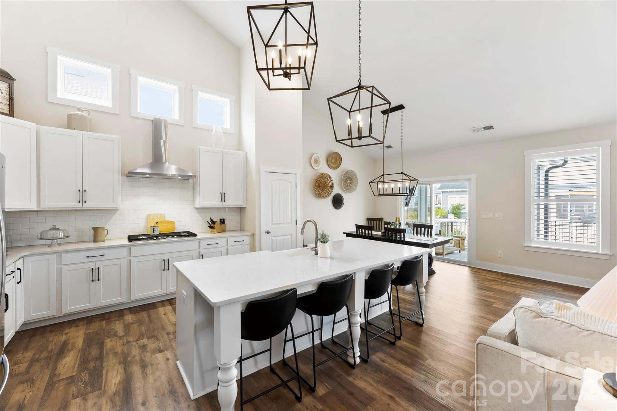 6283 Six String Court Fort Mill, SC 29708 - Photo 8 of 40 a kitchen with granite countertop a sink a stove a dining table and chairs