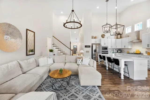 a spacious bedroom with a bed and dresser with mirror
