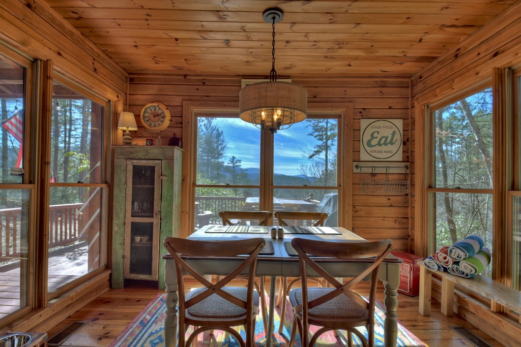 468 Conley Branch Road Blue Ridge, GA 30513 - Photo 6 of 20 a view of a dining room with furniture large windows and wooden floor