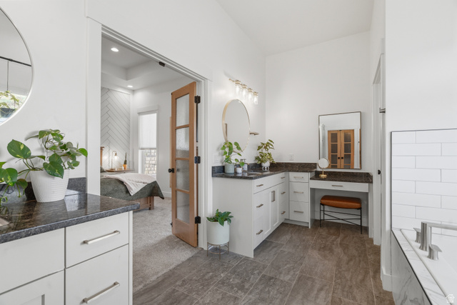 2013 South 100 West Perry, UT 84302 - Photo 24 of 49 Dual vanity with dark stone countertops, white shaker cabinetry, and polished nickel hardware