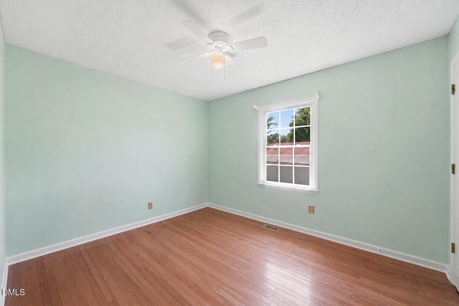 812 East Stagecoach Road Mebane, NC 27302 - Photo 16 of 25 an empty room with wooden floor and windows