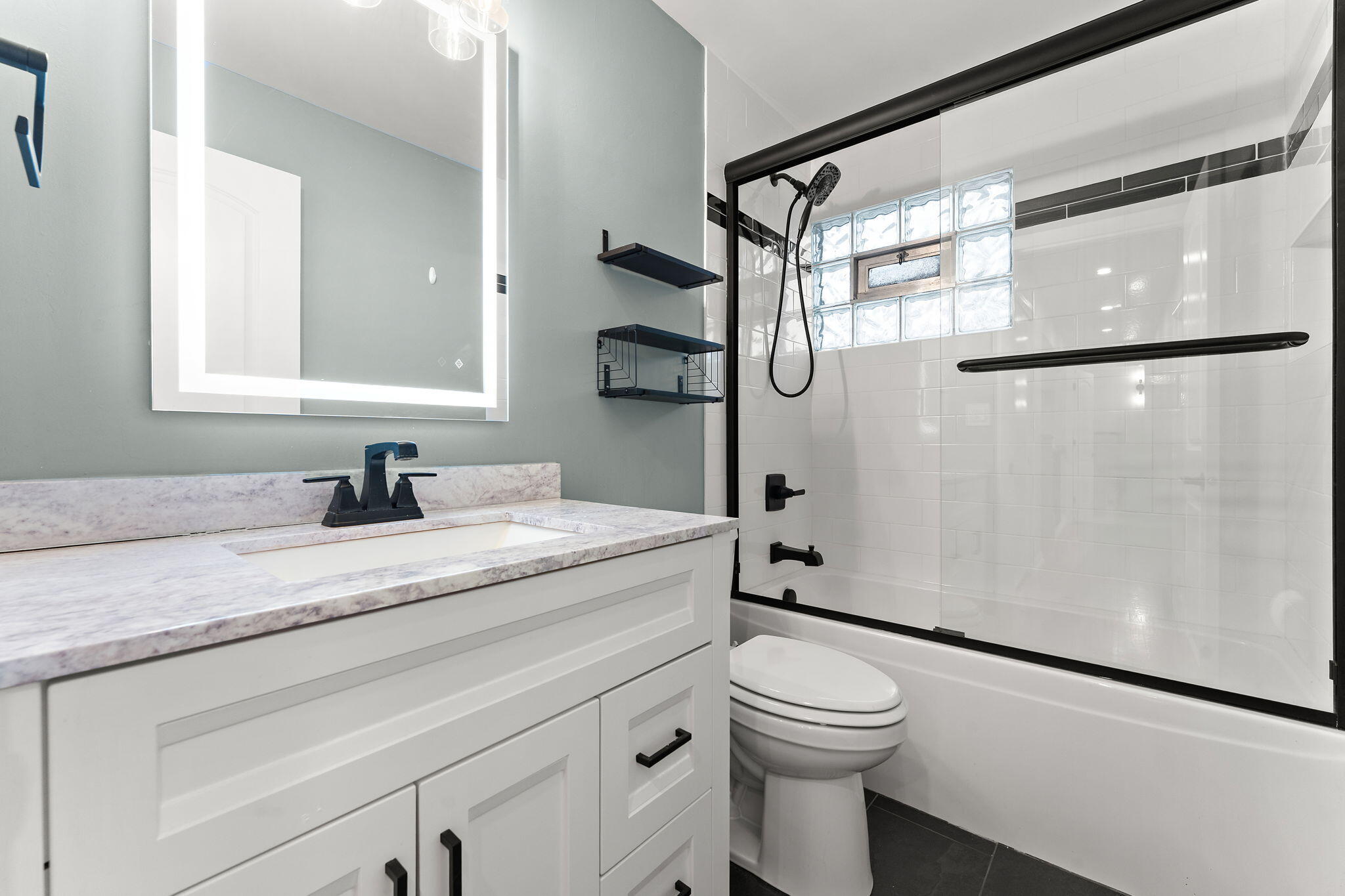 3036 99th Street Highland, IN 46322 - Photo 12 of 22 a bathroom with a granite countertop sink toilet and shower