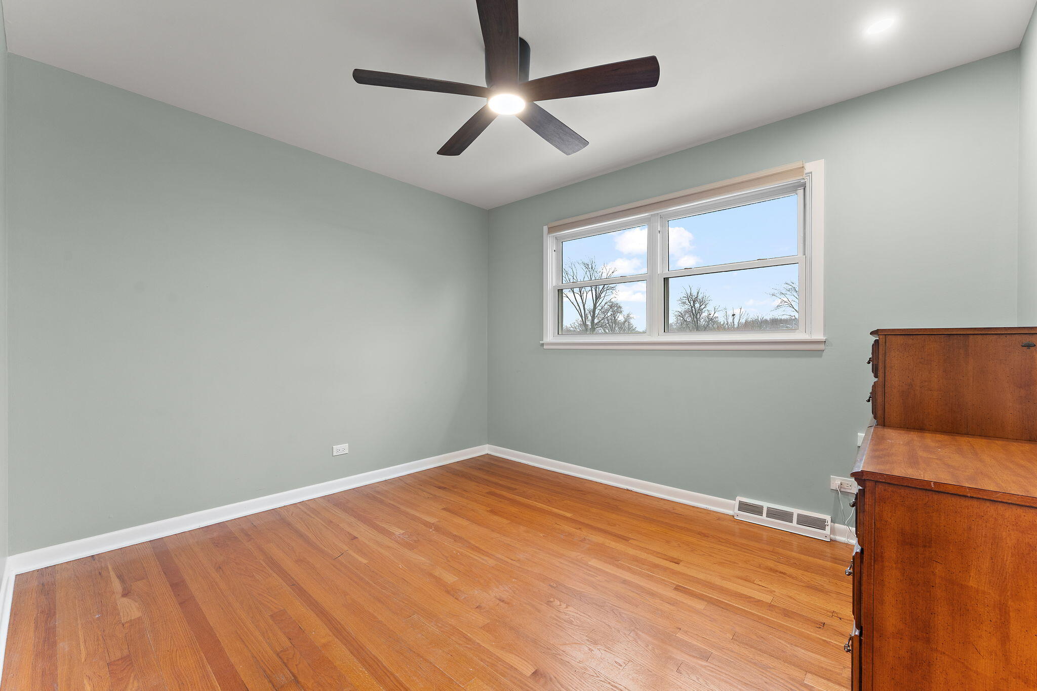 3036 99th Street Highland, IN 46322 - Photo 14 of 22 a view of empty room with wooden floor and fan