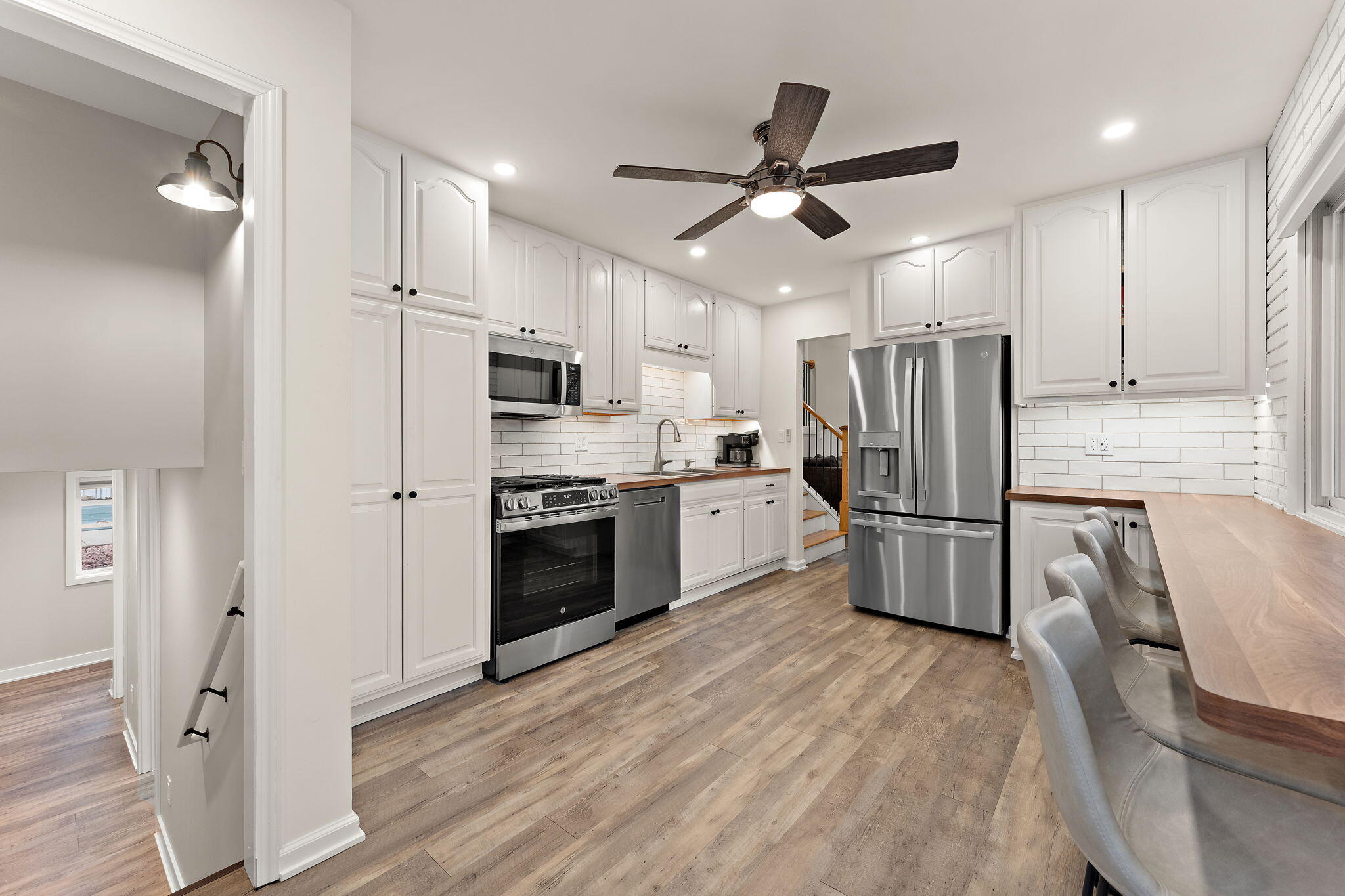 3036 99th Street Highland, IN 46322 - Photo 3 of 22 a kitchen with stainless steel appliances a refrigerator a stove top oven a sink and kitchen island