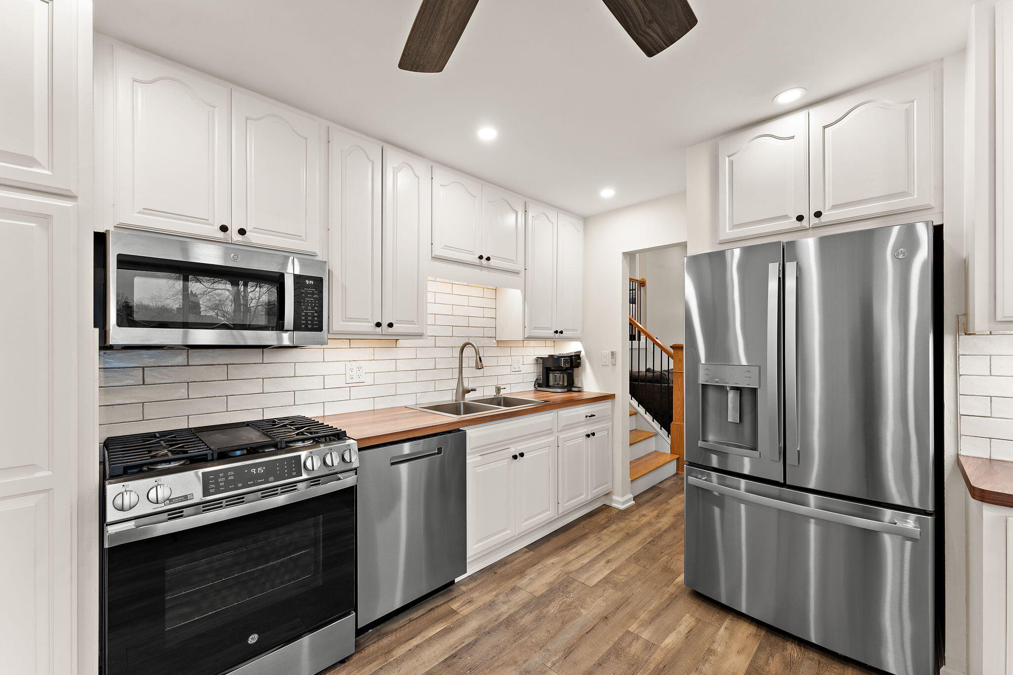 3036 99th Street Highland, IN 46322 - Photo 4 of 22 a kitchen with stainless steel appliances a refrigerator stove and microwave