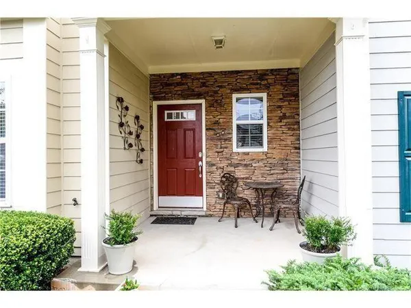 a front view of a house with outdoor seating