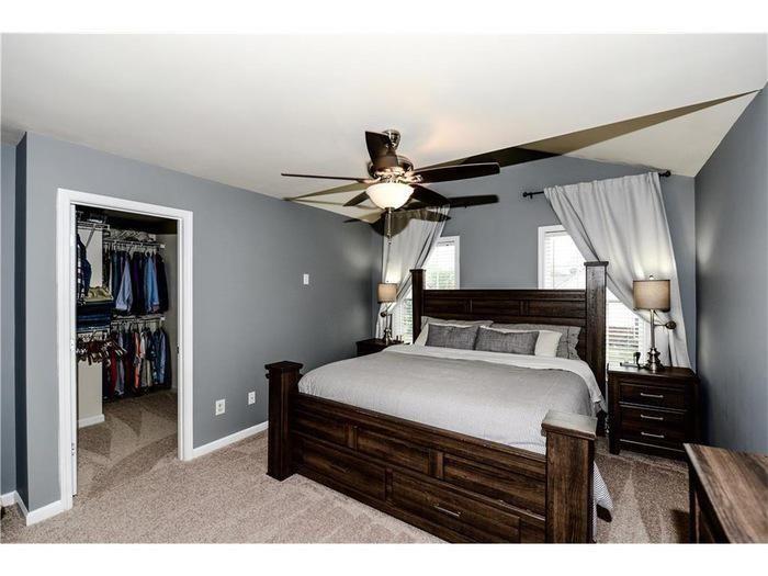 2657 Cedar Drive Lawrenceville, GA 30043 - Photo 18 of 30 a bedroom with a bed and a chandelier