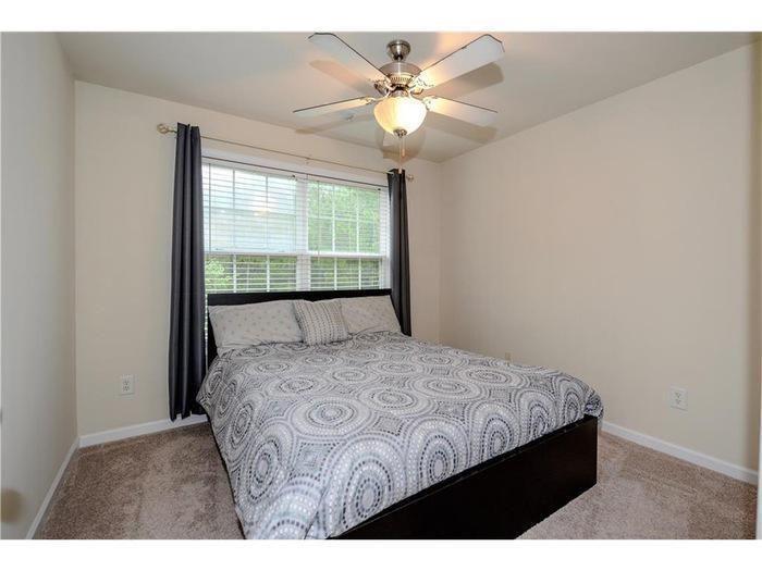 2657 Cedar Drive Lawrenceville, GA 30043 - Photo 24 of 30 a bedroom with a large bed and a large window