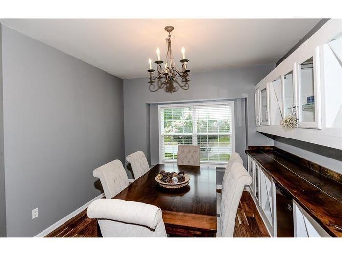 2657 Cedar Drive Lawrenceville, GA 30043 - Photo 5 of 30 a view of a dining room with furniture a chandelier and large windows