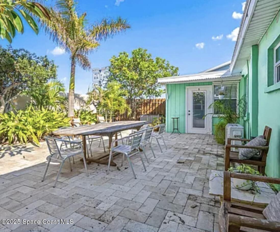 105 Northeast 3rd Street, Unit AD Satellite Beach, FL 32937 - Photo 12 of 27 a view of a patio with table and chairs and potted plants