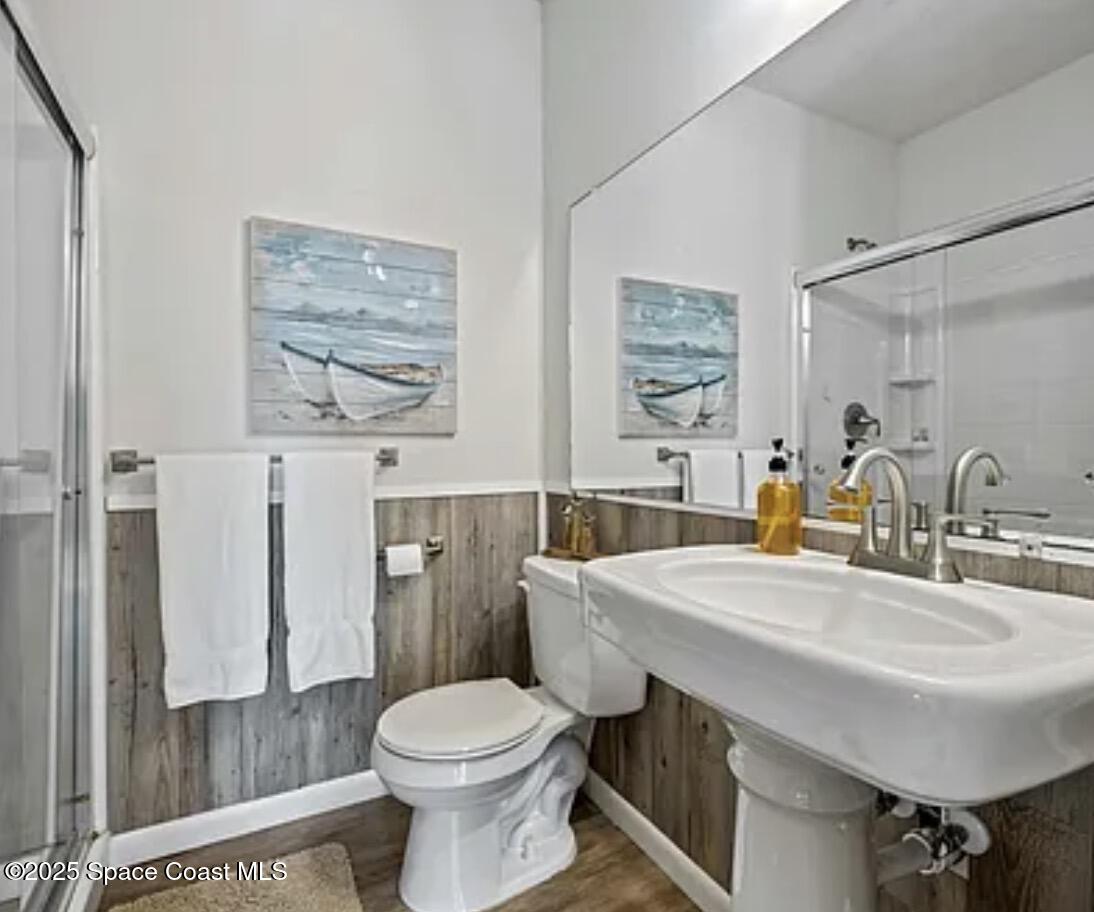 105 Northeast 3rd Street, Unit AD Satellite Beach, FL 32937 - Photo 18 of 27 a bathroom with a sink toilet and shower