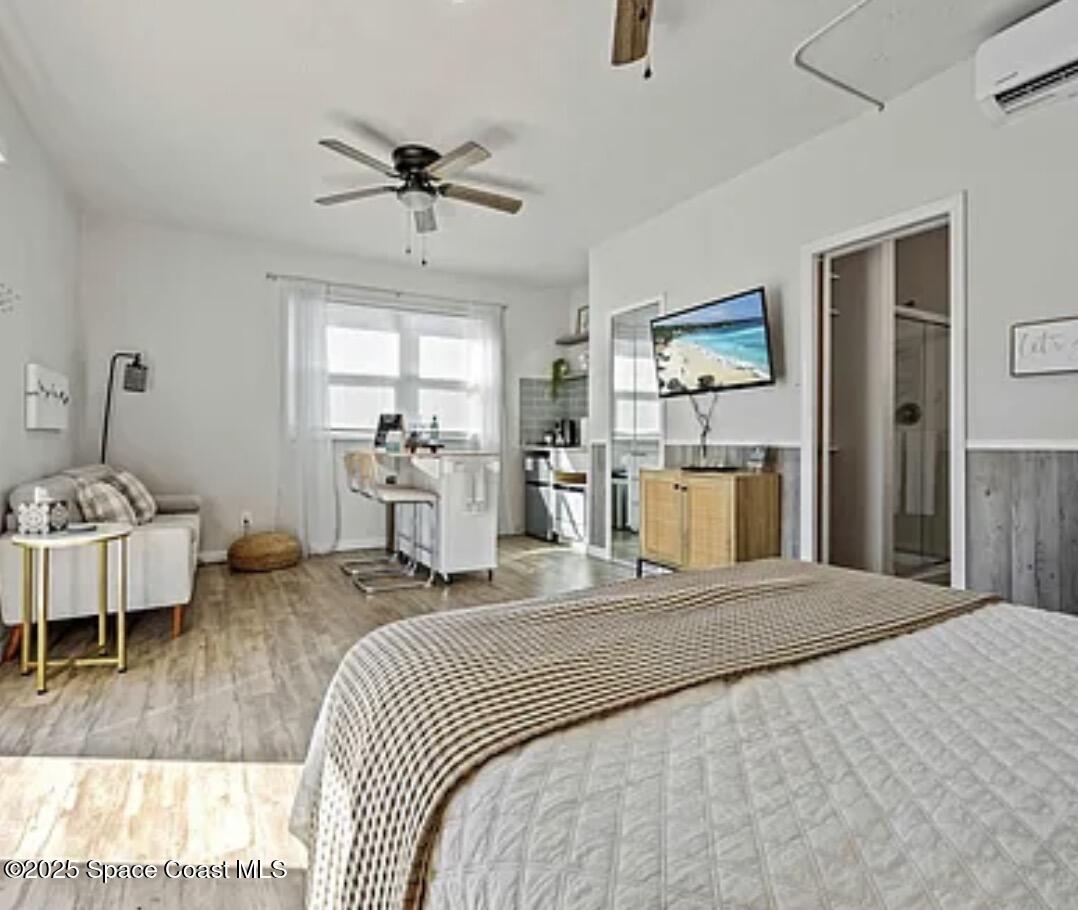 105 Northeast 3rd Street, Unit AD Satellite Beach, FL 32937 - Photo 20 of 27 a bedroom with a bed and a mirror