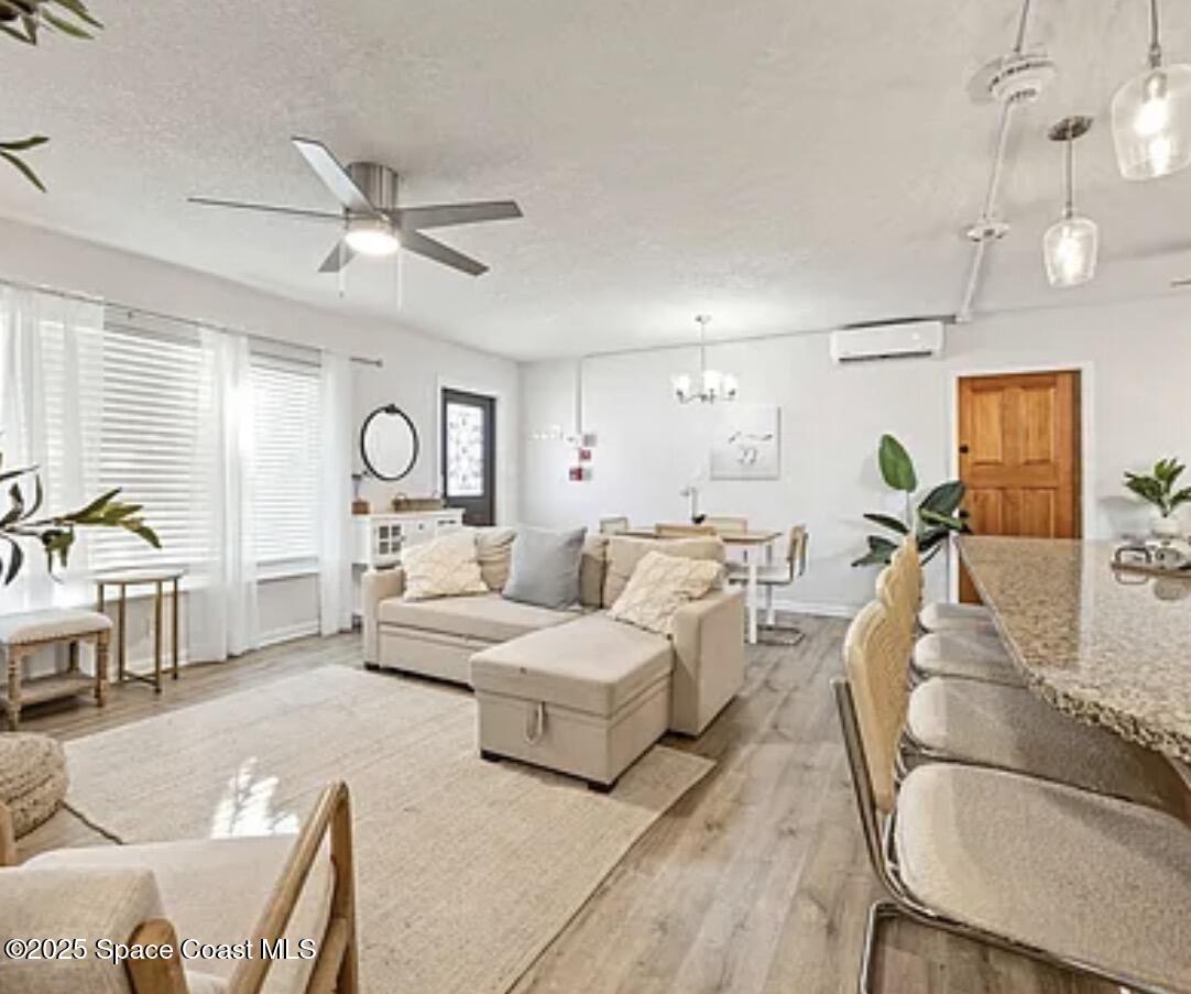 105 Northeast 3rd Street, Unit AD Satellite Beach, FL 32937 - Photo 22 of 27 a living room with furniture and a large window