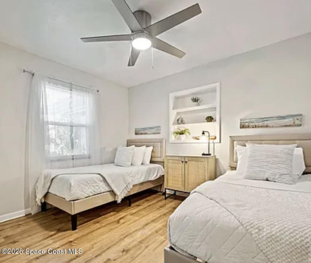 105 Northeast 3rd Street, Unit AD Satellite Beach, FL 32937 - Photo 26 of 27 a bedroom with two beds and a large window