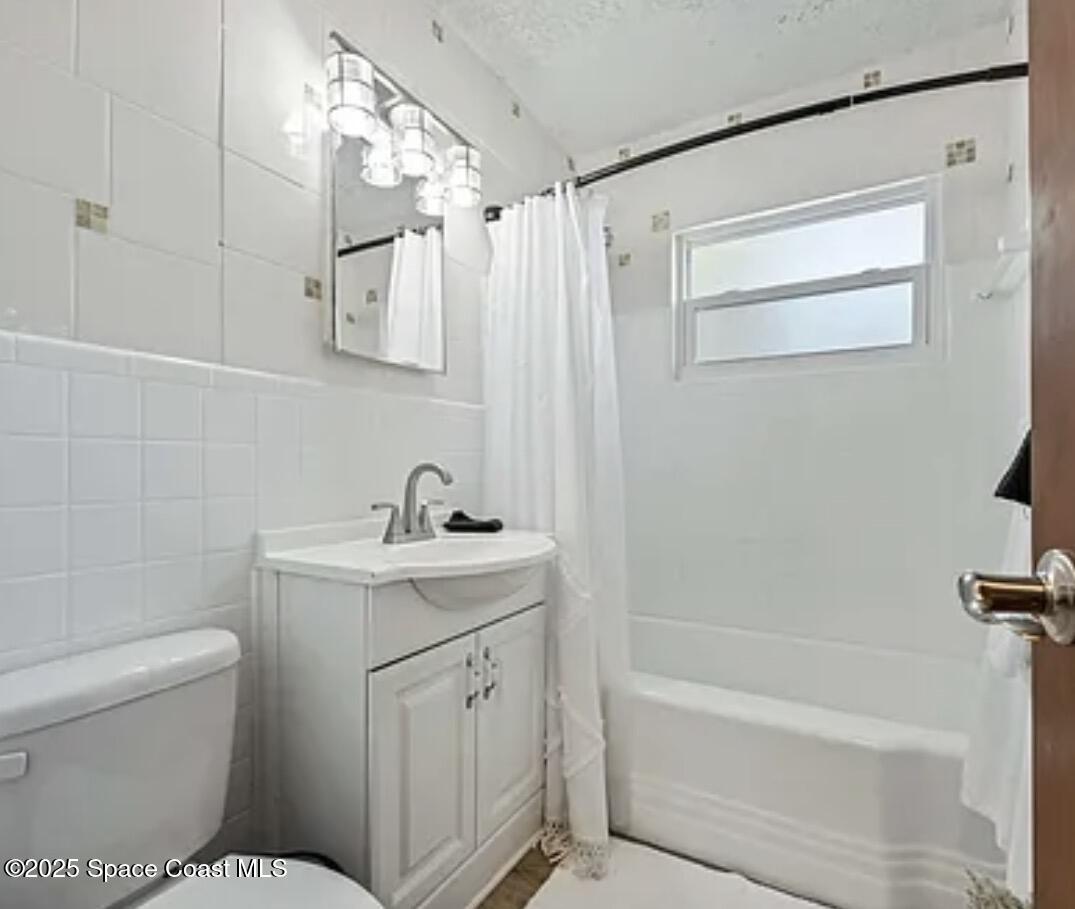 105 Northeast 3rd Street, Unit AD Satellite Beach, FL 32937 - Photo 27 of 27 a bathroom with a sink a toilet and shower