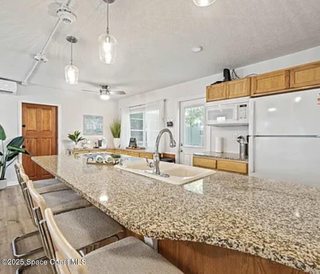 105 Northeast 3rd Street, Unit AD Satellite Beach, FL 32937 - Photo 8 of 27 a view of a living room and kitchen
