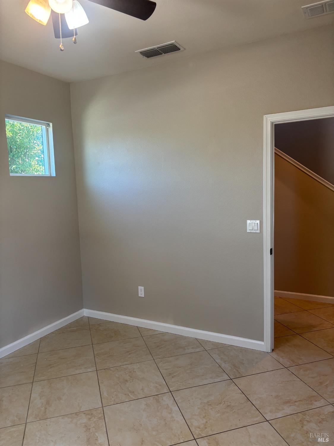 5114 Kolton Place Rohnert Park, CA 94928 - Photo 8 of 37 en empty room with windows and chandelier fan