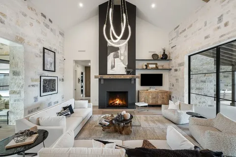a living room with furniture a fireplace and a table