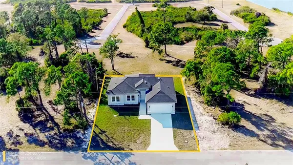 an aerial view of a house with a backyard