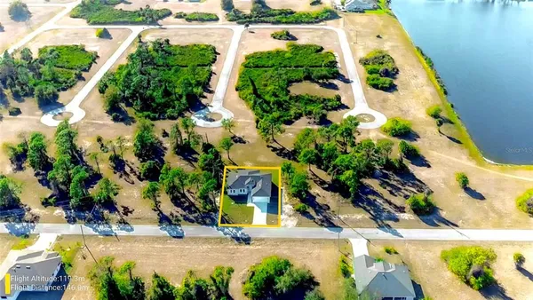 an aerial view of a house with a lake view