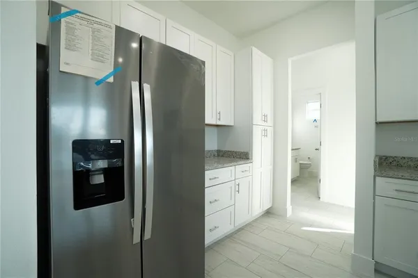 a bathroom with a granite countertop sink a toilet and a mirror