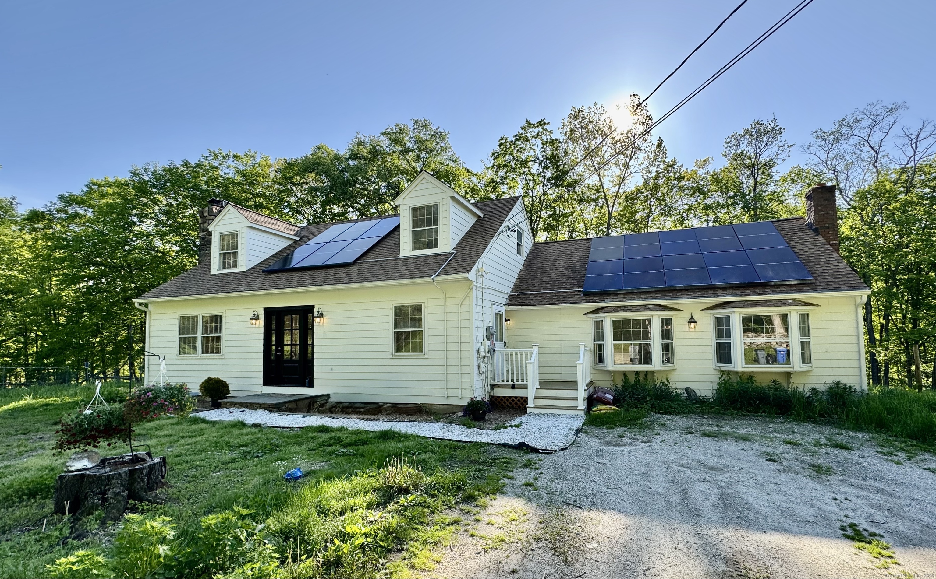 23 Burnett Road New Milford, CT 06776 - Photo 1 of 1 a view of a yard in front of a house with plants and large tree