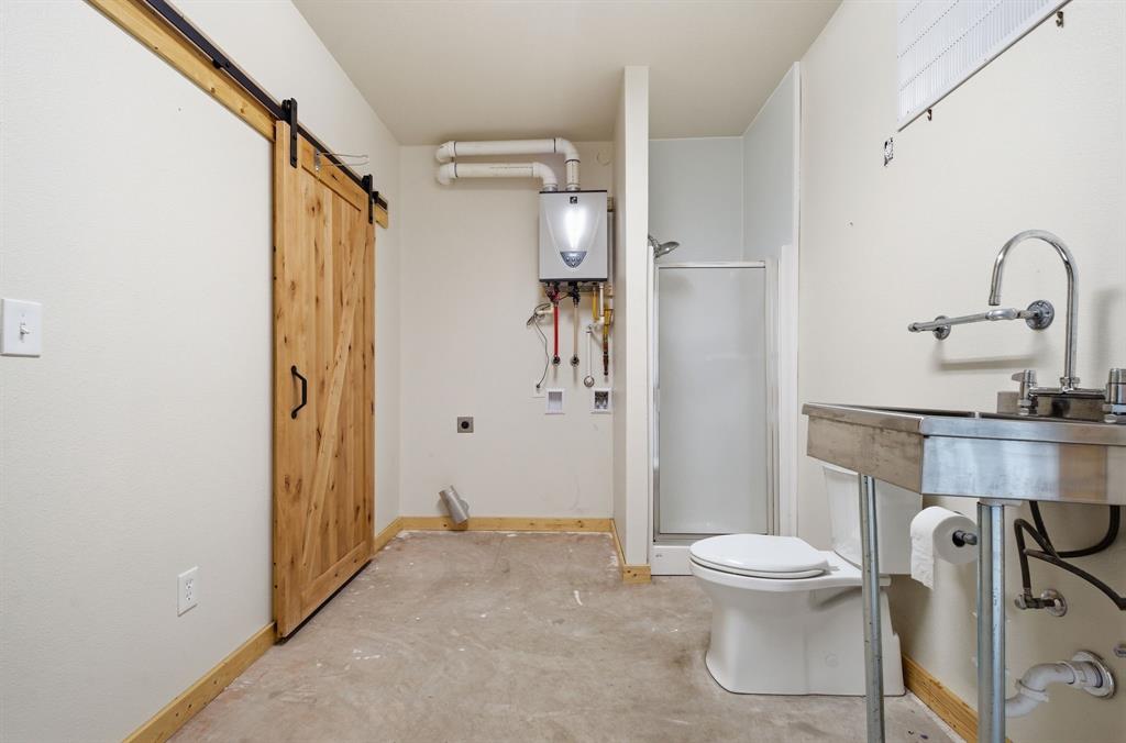 465 Emberson Ranch Road Pilot Point, TX 76258 - Photo 33 of 40 a bathroom with a toilet and a sink