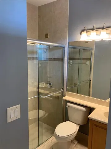 a bathroom with a toilet and a shower
