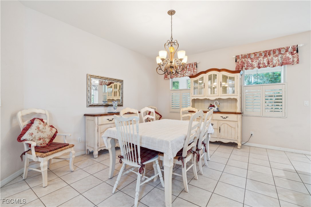 9475 Silver Pine Loop Fort Myers, FL 33967 - Photo 12 of 34 a view of a dining room with furniture and chandelier