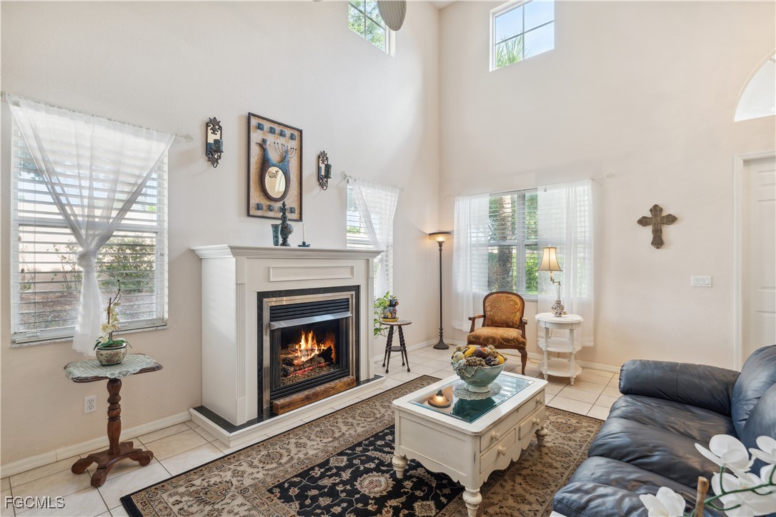 9475 Silver Pine Loop Fort Myers, FL 33967 - Photo 16 of 34 a living room with furniture and a fireplace