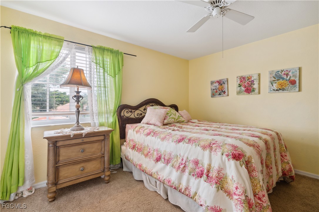 9475 Silver Pine Loop Fort Myers, FL 33967 - Photo 17 of 34 a bedroom with a bed and a window