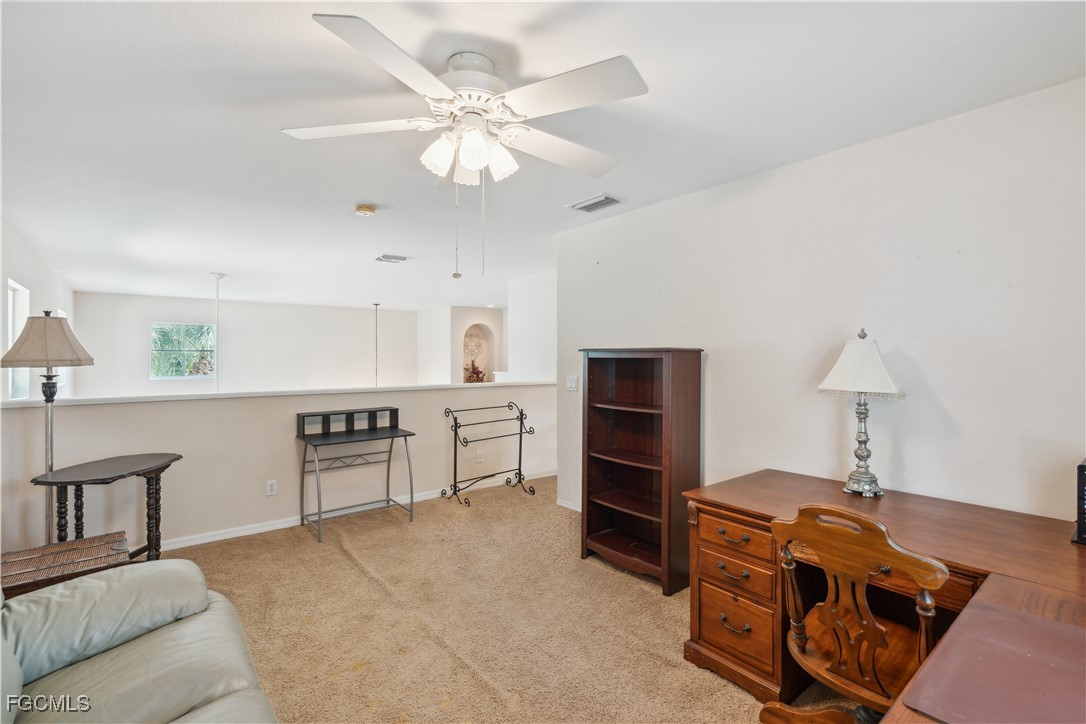 9475 Silver Pine Loop Fort Myers, FL 33967 - Photo 20 of 34 a view of a workspace with furniture and a lamp