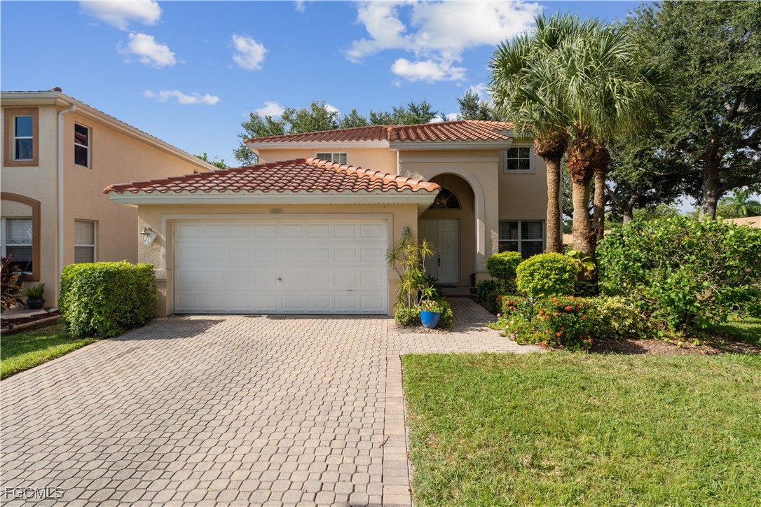 9475 Silver Pine Loop Fort Myers, FL 33967 - Photo 2 of 34 a front view of a house with a yard