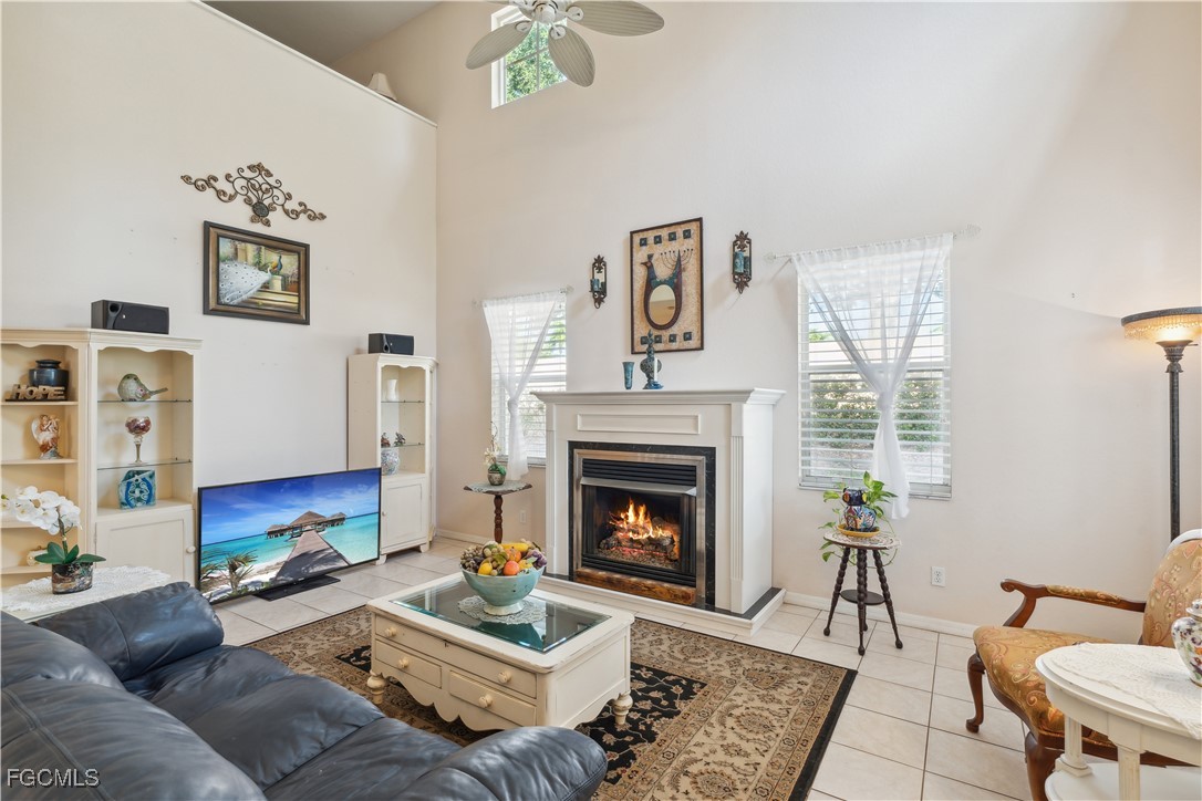 9475 Silver Pine Loop Fort Myers, FL 33967 - Photo 22 of 34 a living room with furniture and a fireplace