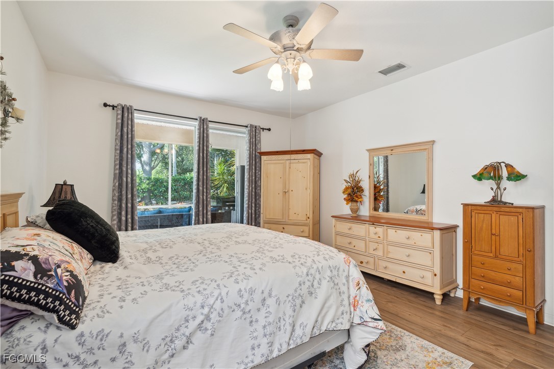 9475 Silver Pine Loop Fort Myers, FL 33967 - Photo 24 of 34 a bedroom with a bed and a dresser