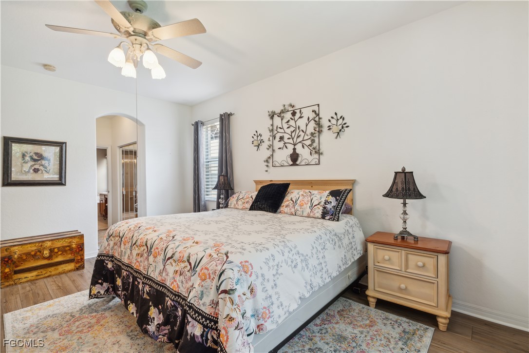 9475 Silver Pine Loop Fort Myers, FL 33967 - Photo 25 of 34 a bedroom with a bed and a chandelier