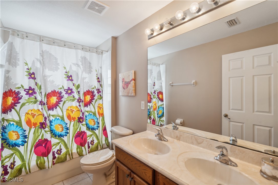 9475 Silver Pine Loop Fort Myers, FL 33967 - Photo 29 of 34 a bathroom with a sink mirror vanity and toilet
