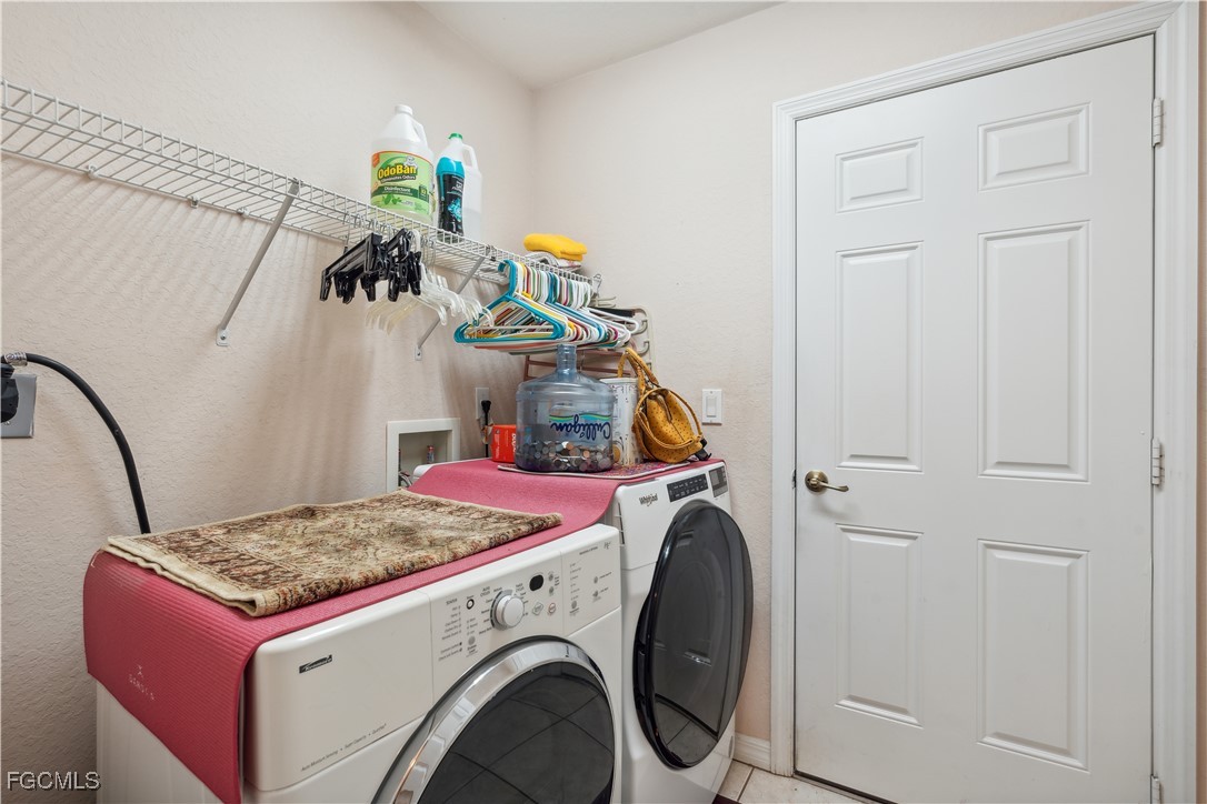 9475 Silver Pine Loop Fort Myers, FL 33967 - Photo 31 of 34 a utility room with dryer and washer