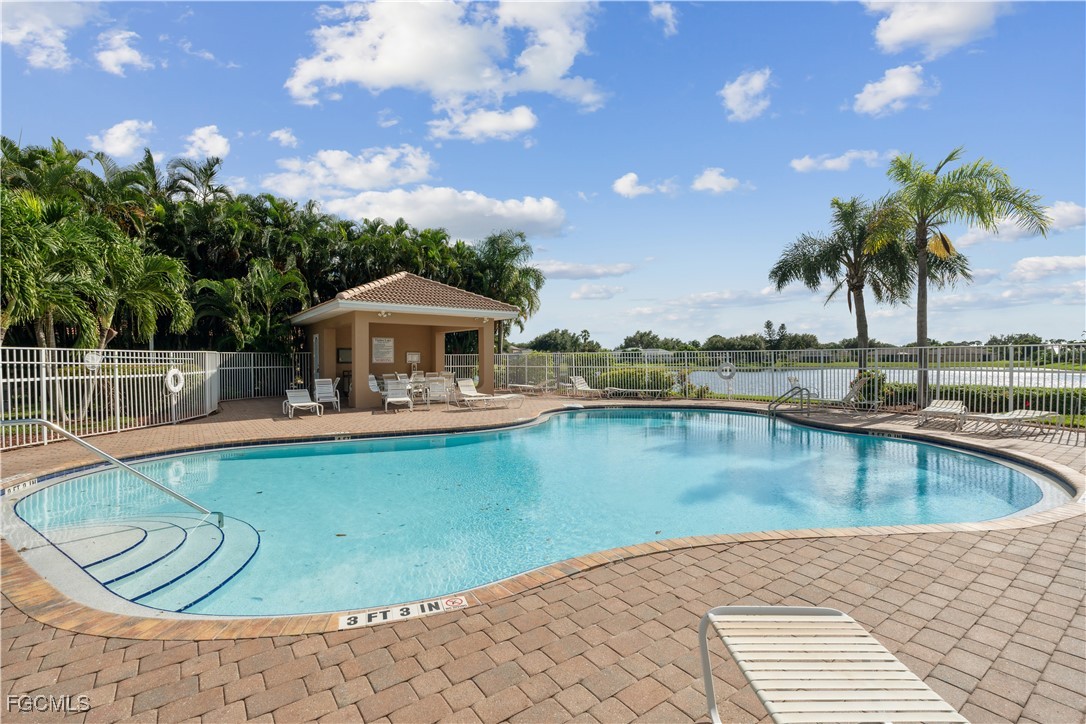 9475 Silver Pine Loop Fort Myers, FL 33967 - Photo 33 of 34 a view of a swimming pool with a lounge chair
