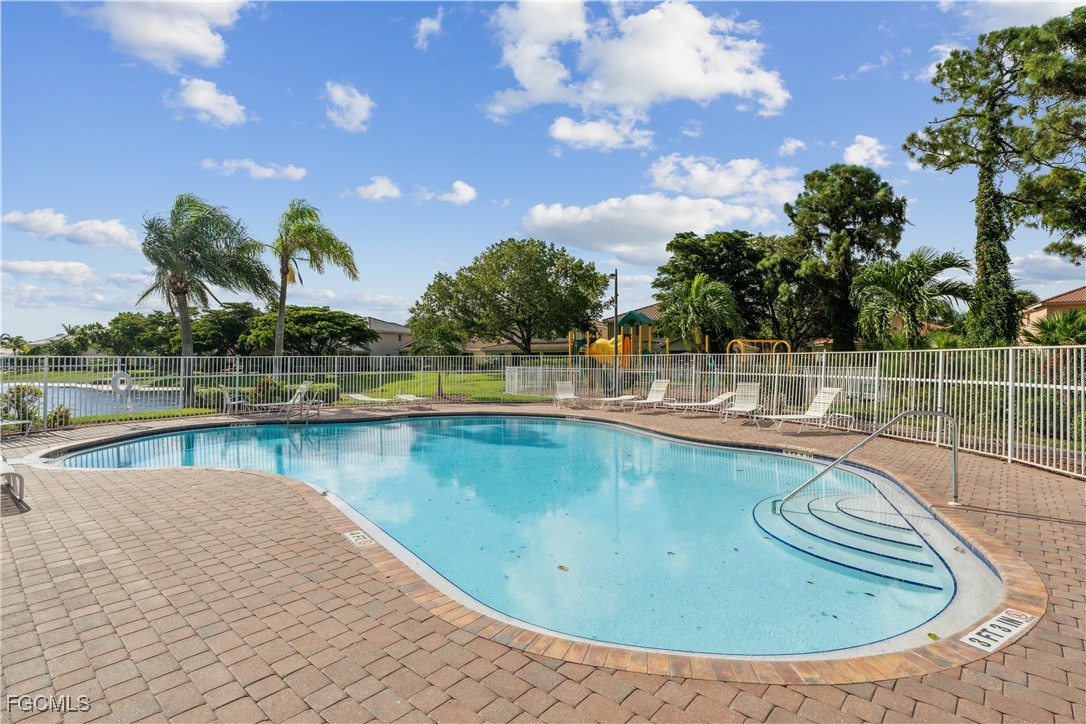 9475 Silver Pine Loop Fort Myers, FL 33967 - Photo 34 of 34 a view of a swimming pool with outdoor seating and plants