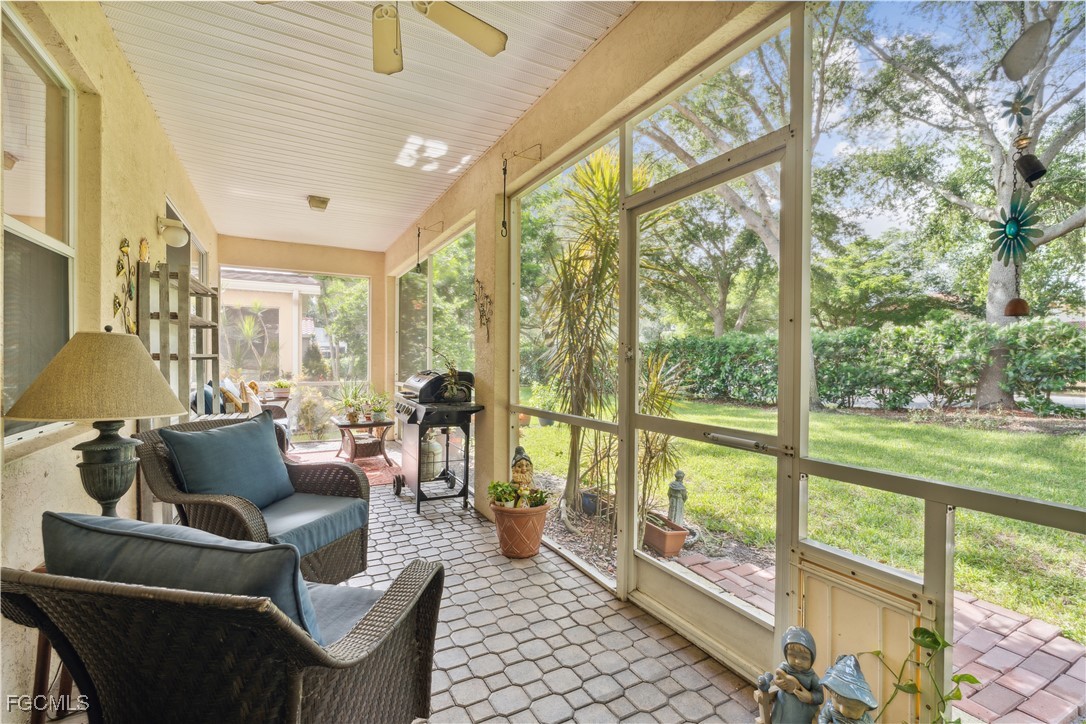 9475 Silver Pine Loop Fort Myers, FL 33967 - Photo 4 of 34 a living room with furniture and a floor to ceiling window